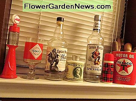 Retro Avon Flaschen, extra großer Texaco Becher voller alter Schraubenzieher und leere Captain Morgan Flaschen. Retro Avon bottles, extra large Texaco mug full of antique screwdrivers and empty Captain Morgan bottles.