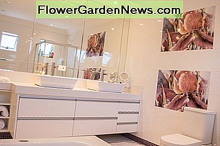 Die Wand hinter dem Waschbecken mit Spiegel zu füllen, ist ein alter Trick, um den Raum größer zu machen. Filling the wall behind the sink with mirror is an old trick for making the room feel bigger.