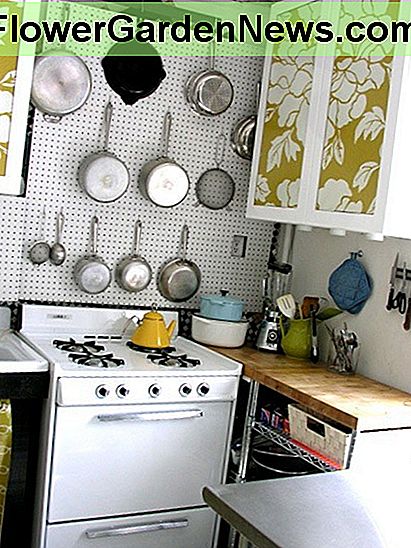 Installing the peg board over the stove is a great space-saving option for this smaller kitchen.